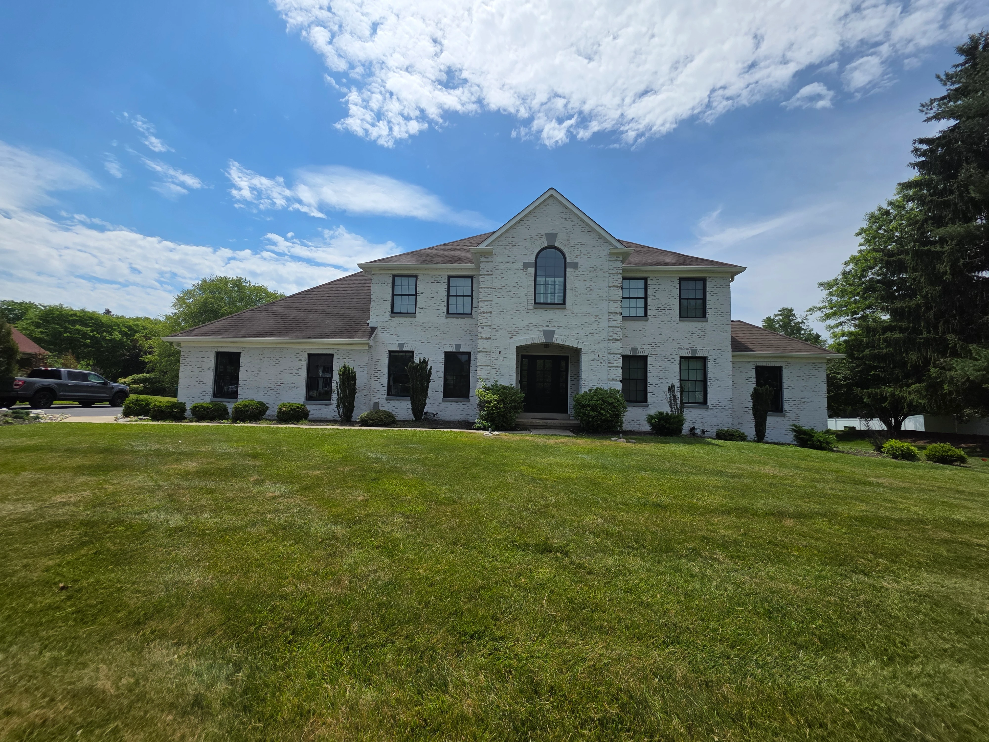 Slurry finish creating a softly unified appearance across a two story brick exterior